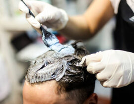 Man in a hair salon coloring hair